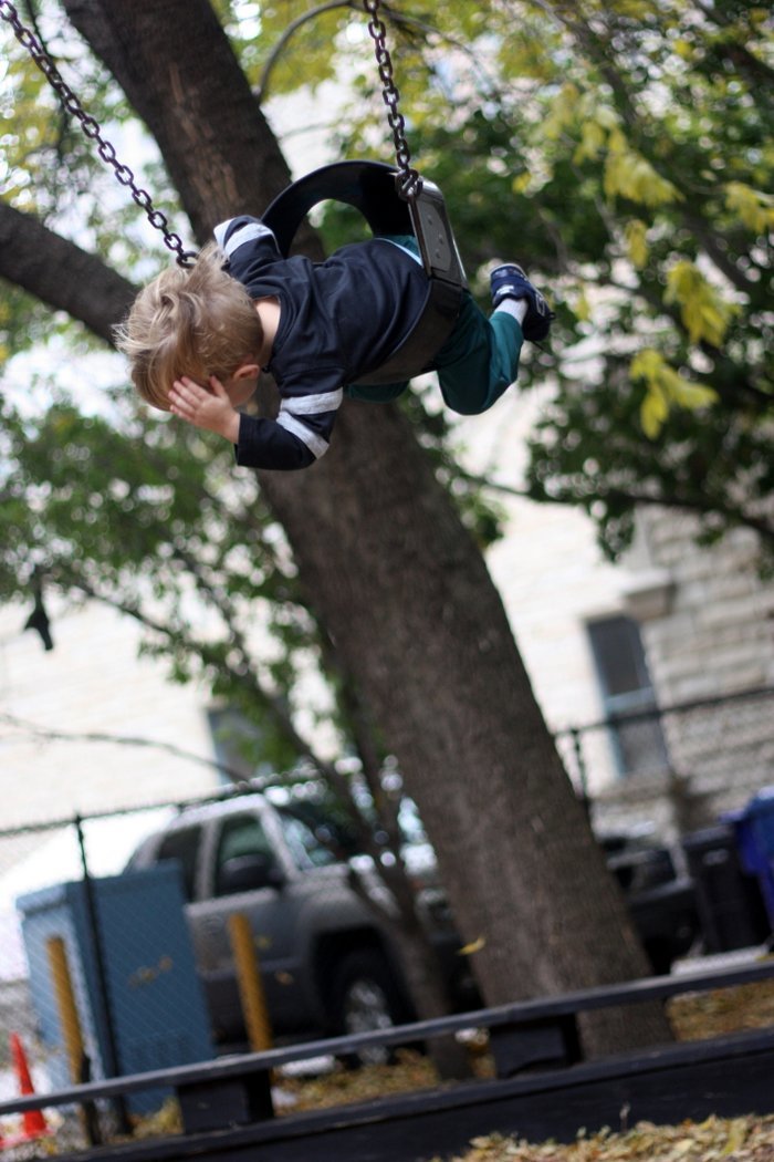 FashionablyEmployed.com | Guide to Visiting Chicago during the Summer with Kids | Swinging at Seneca Playlot Park