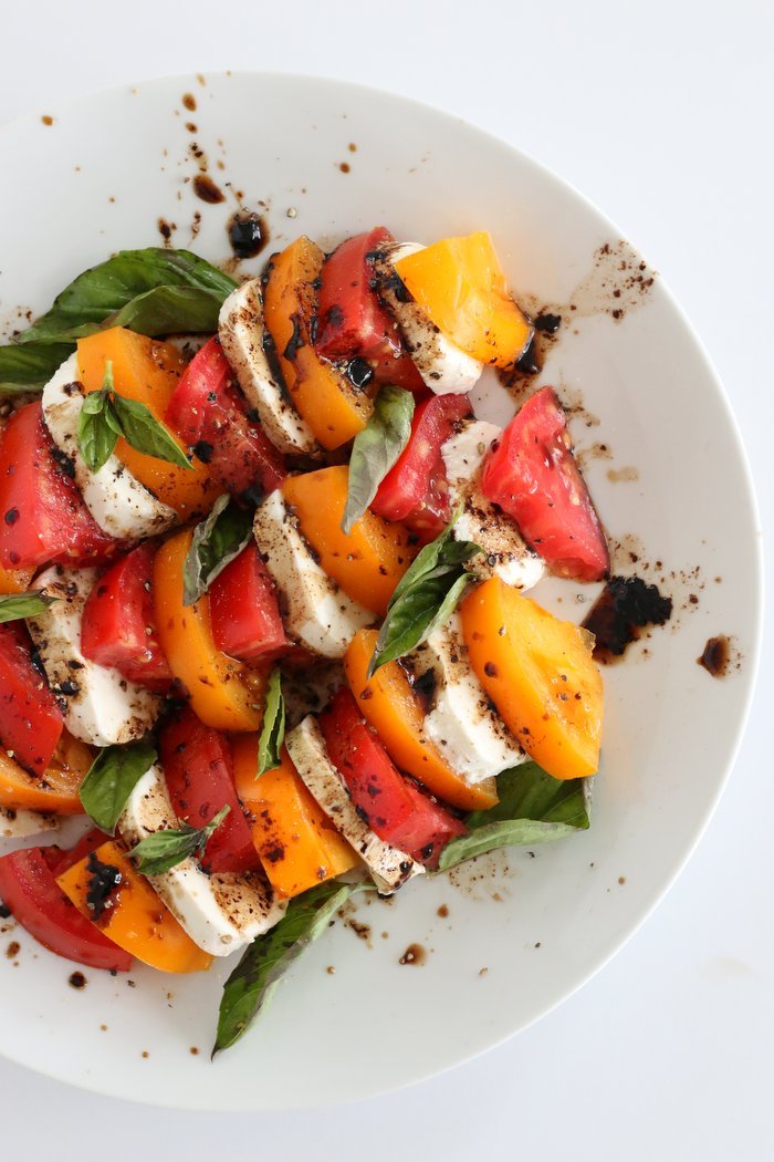 FashionablyEmployed.com | Fresh vegetarian meal including tomato, mozzarella and basil caprese with lemon, garlic eggplant bruschetta. Everything came fresh the farmers' market for a light and local summer meal. 