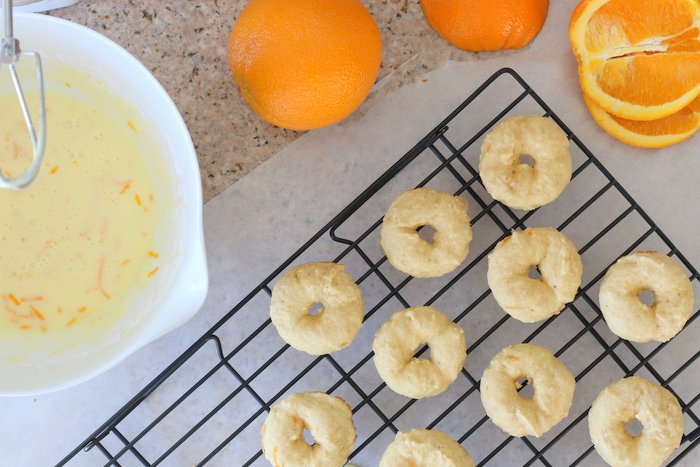 Try this fun and easy orange pineapple mocktail paired with fun orange baked donuts with orange glaze. It's all from scratch but made with simple ingredients and tricks any beginner baker can master. Click through for details!