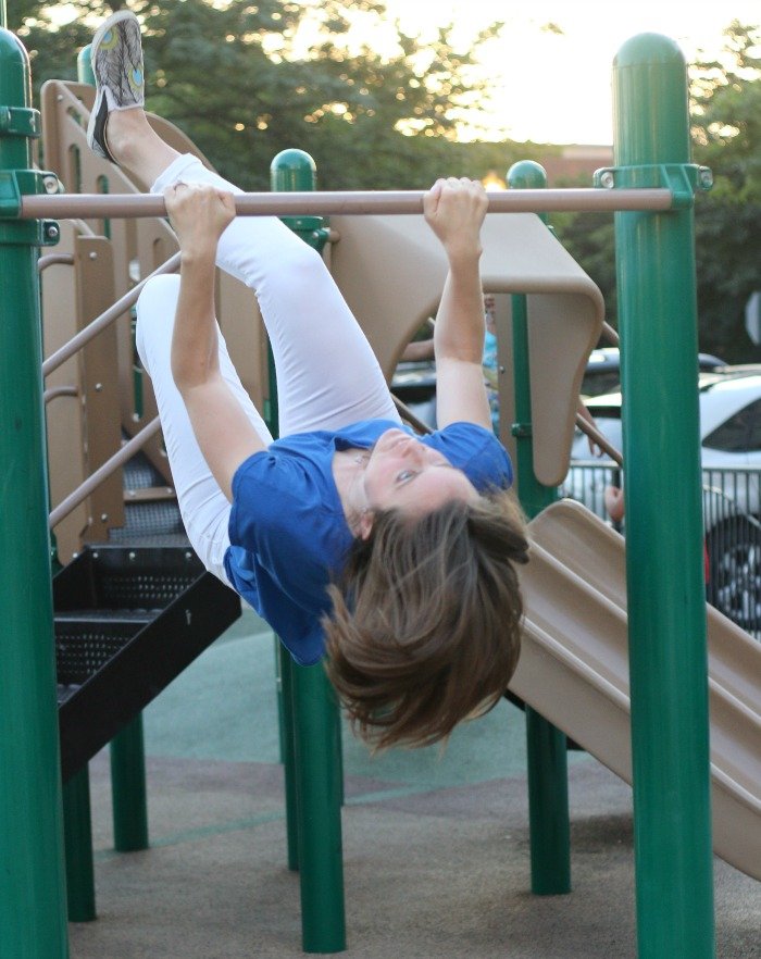 woman playing on the monkey bars at a playground