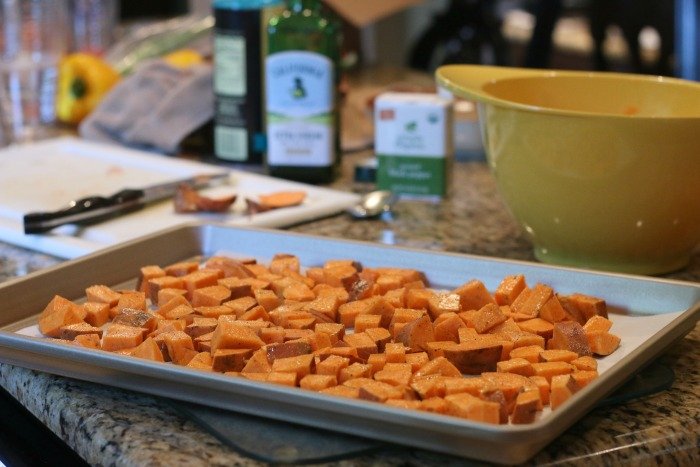 chopped sweet potatoes on a cookie sheet before being cooked