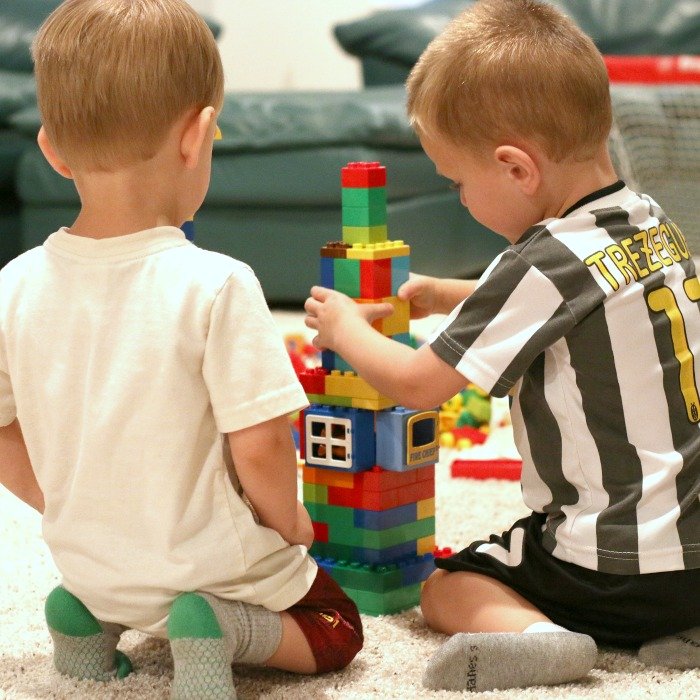 two-little-boys-building-a-rocketship-from-duplo-legos