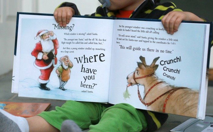 little-boy-holding-a-christmas-personalized-book