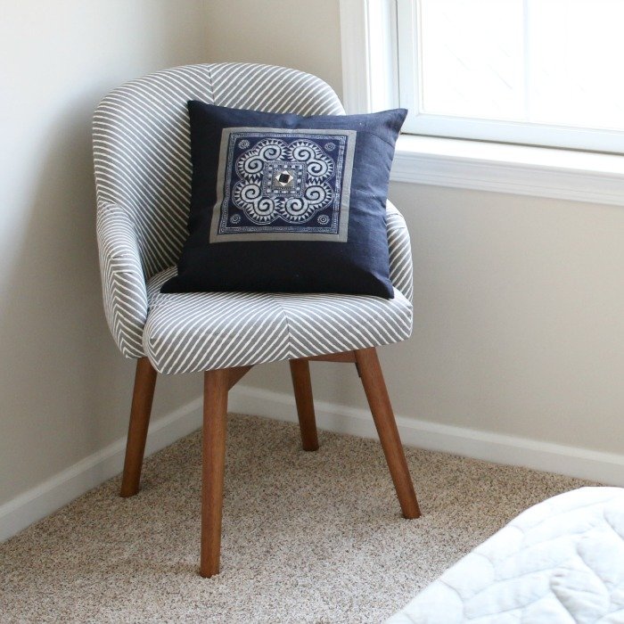 west-elm-chair-with-ten-thousand-villages-blue-decorative-pillow-with-bed-corner-square