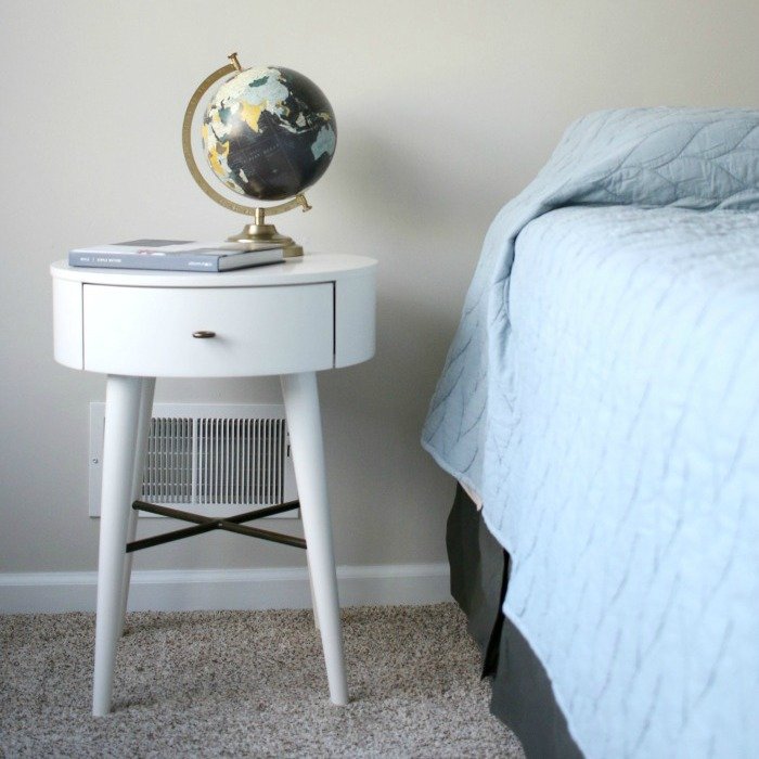 nightstand-with-globe-and-book-next-to-bed-square