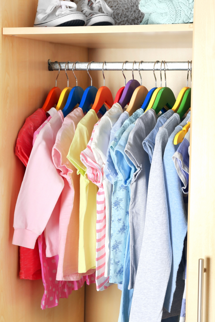 children's clothes hanging in a closet