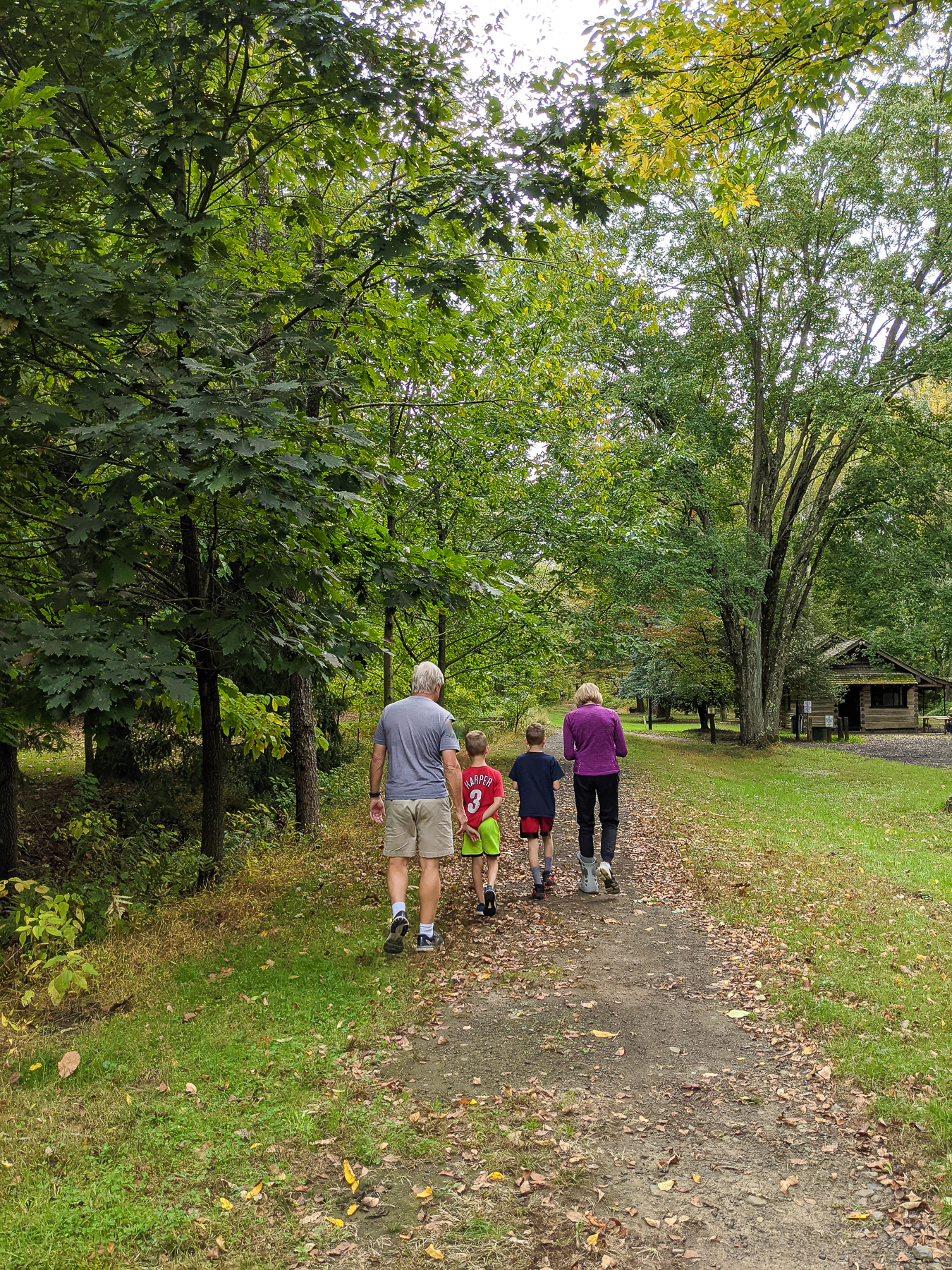 Grandparents and two boys walking on a path outdoors