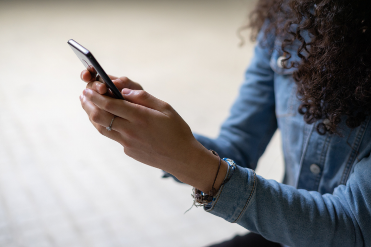 Hands holding a cell phone