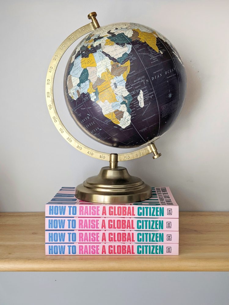 A globe sitting on top of two copies of the book How to raise a global citizen.