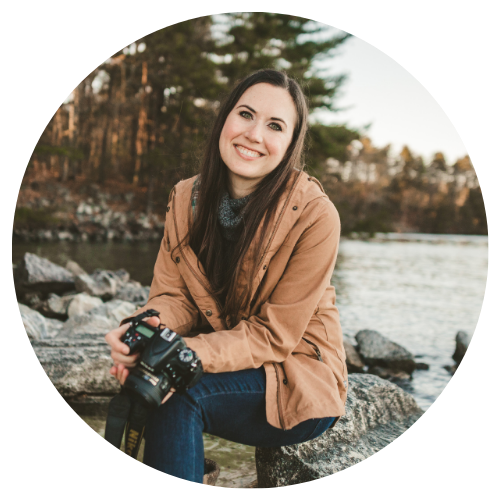 headshot of Reese Moore with her camera in front of a lake in the woods