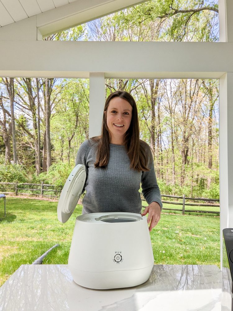 woman behind a Lomi electric composter sitting on a table