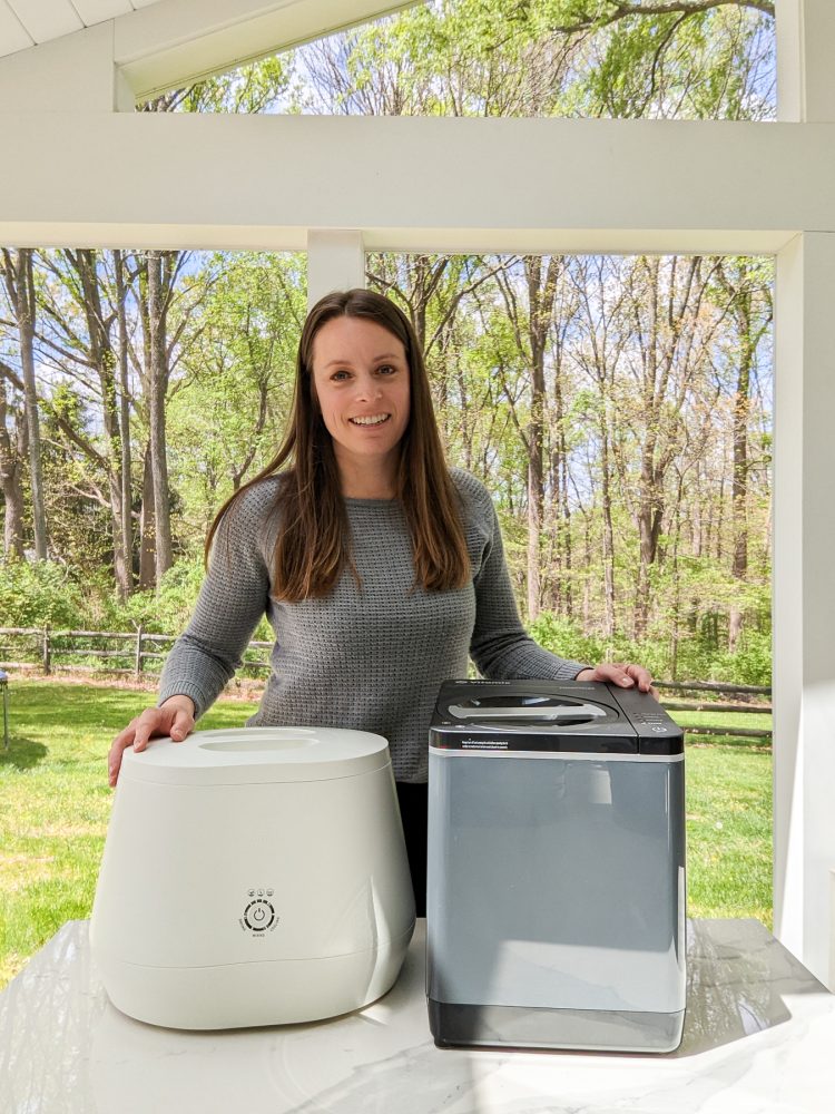 woman with Lomi kitchen composter and Vitamix FoodCycler machine on a table in front of her