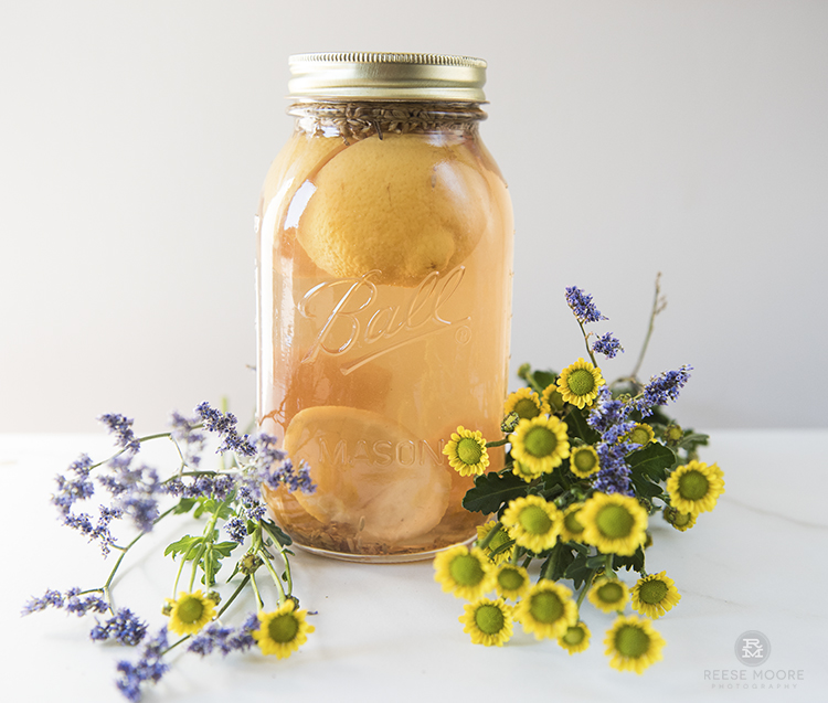 Orange and clove DIY scented vinegar cleanser in a mason jar