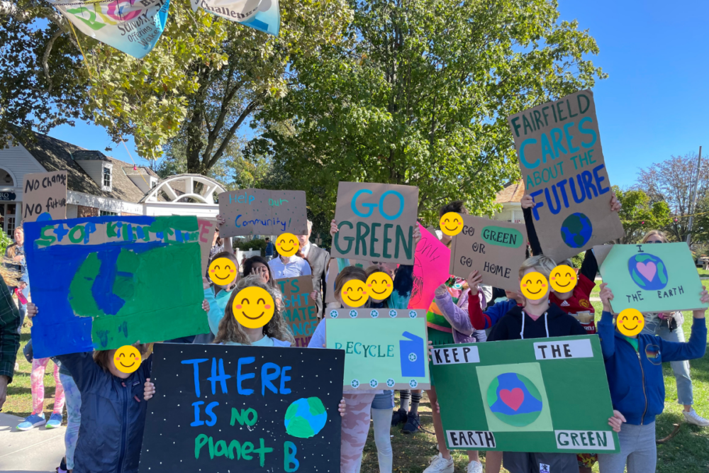 kids holding climate action signs together