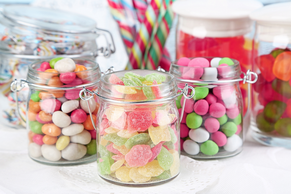 candy in glass jars for Sustainable DIY Candy Buffet Table Ideas